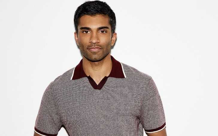 Dashing Nikesh Patel in a faded greyish t-shirt with dark red neck color.