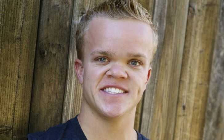 Kyle Pacek smiles at the camera.