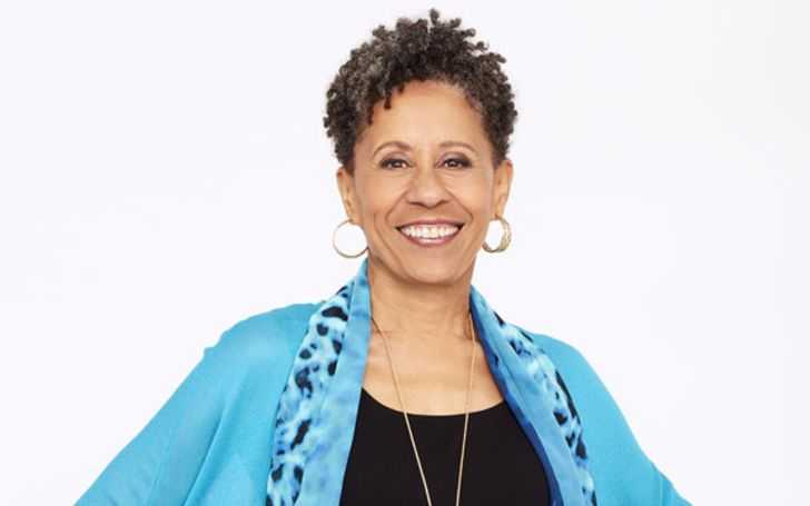 Vernee Watson-Johnson in a blue coat smiling at the camera.