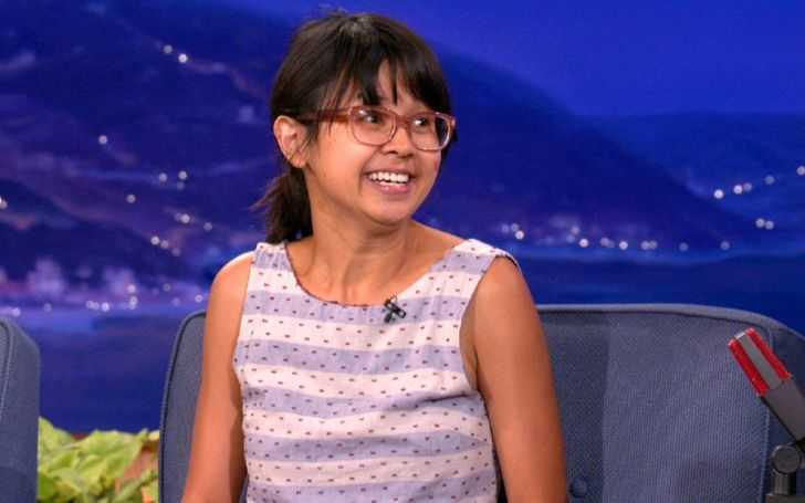 Charlyne Yi in a purple-white top at an interview.