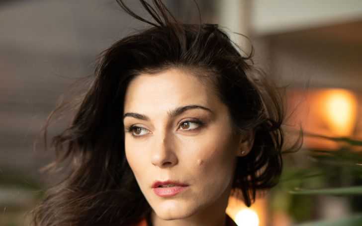 Elysia Rotaru with black hair and brown eyes