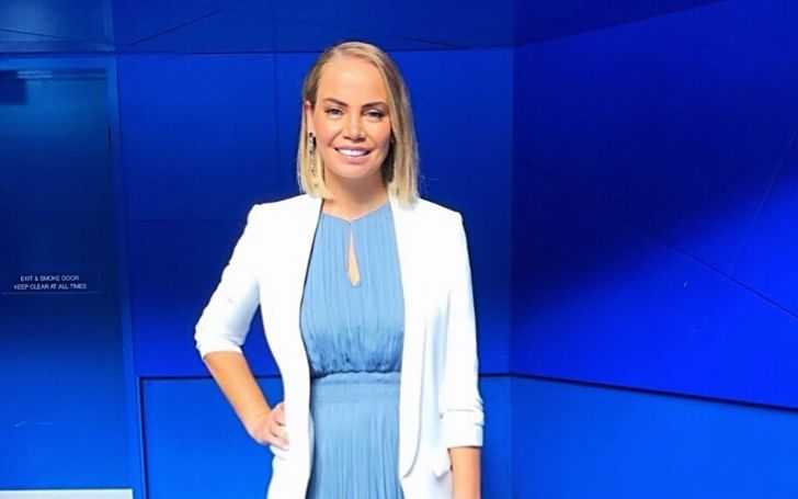 Jelena Dokic, who has an estimated total net worth of $5 million, in a blue dress and white sweater.