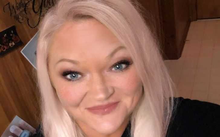Libby Offutt in a blond hair smiles at the camera.