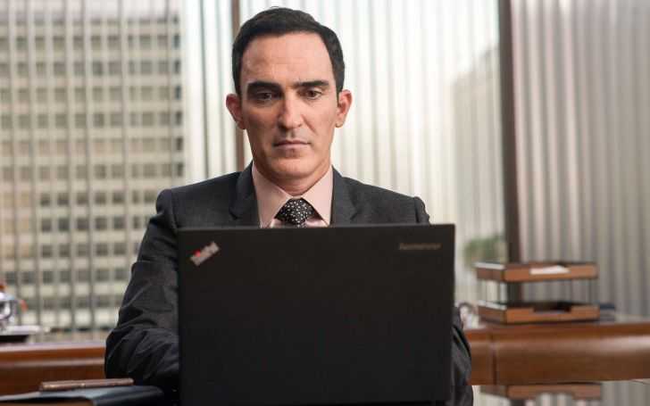 Patrick Fischler working in a laptop.
